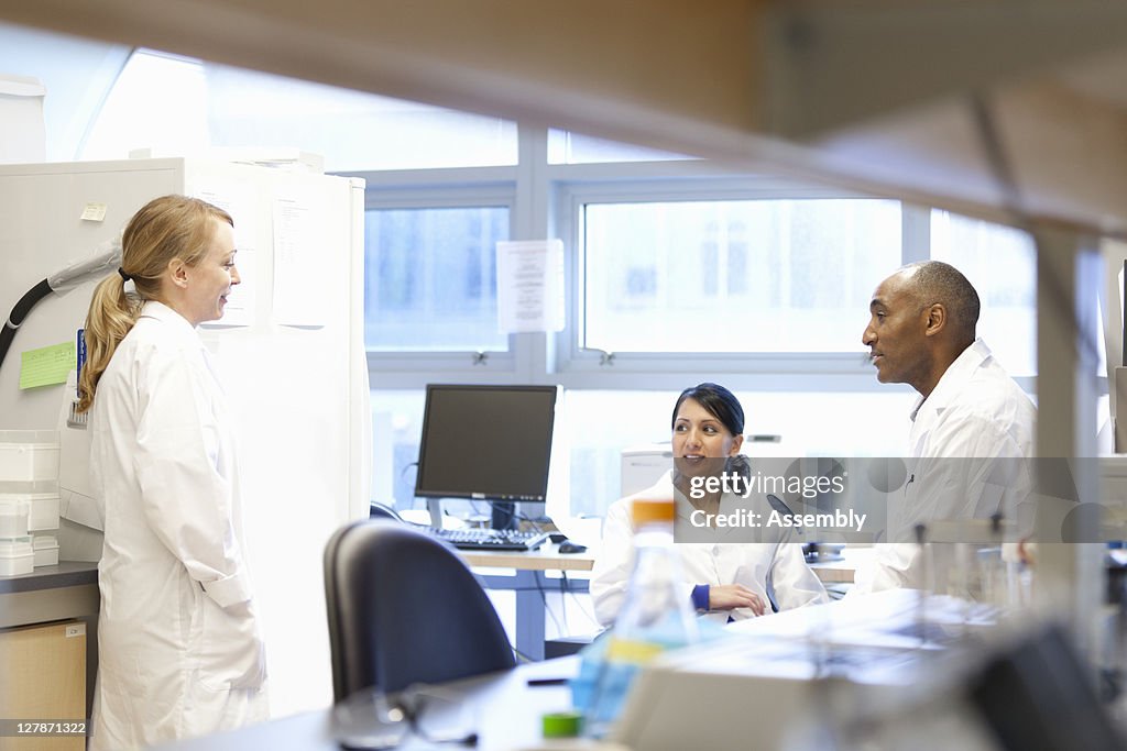 Group of scientists talking in lab