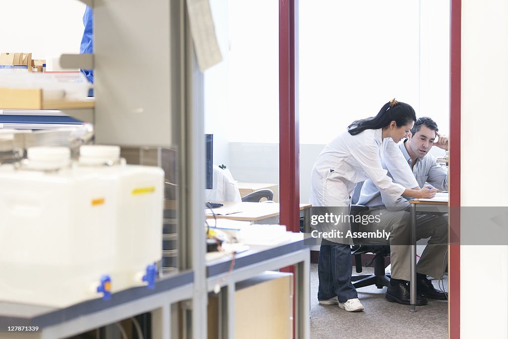 Scientists discussing ideas in lab office