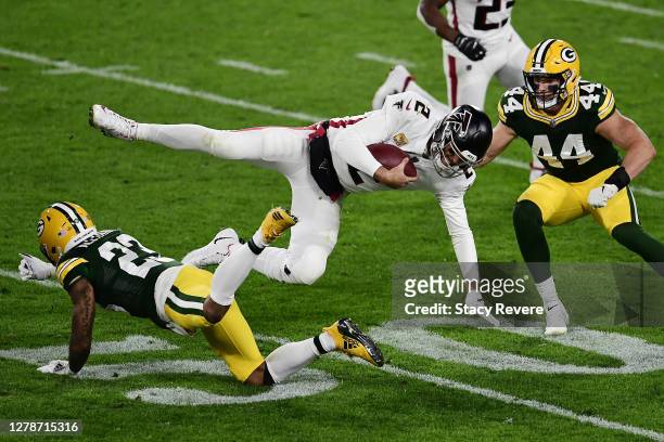 Matt Ryan of the Atlanta Falcons is tackled by Jaire Alexander of the Green Bay Packers during the second half at Lambeau Field on October 05, 2020...