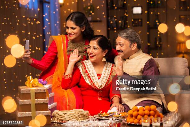 family diwali celebrate - stock photo - diwali family stock pictures, royalty-free photos & images