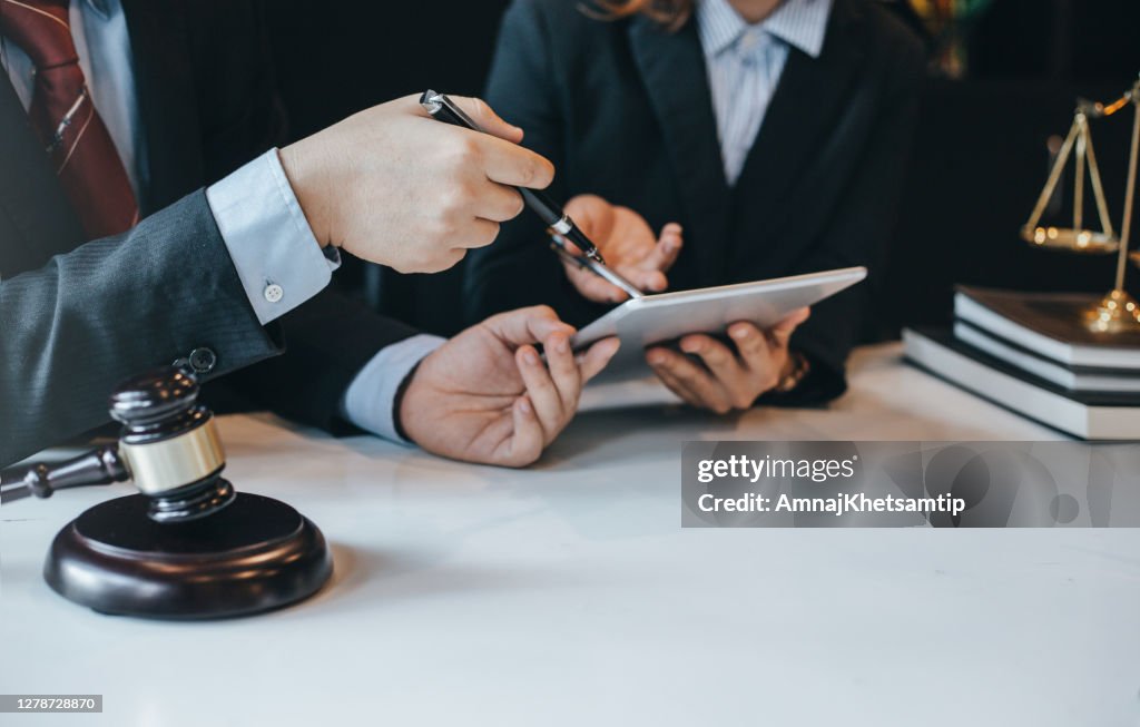 At the meeting, a team of lawyers discussed the lawsuit. Concept of law and justice.