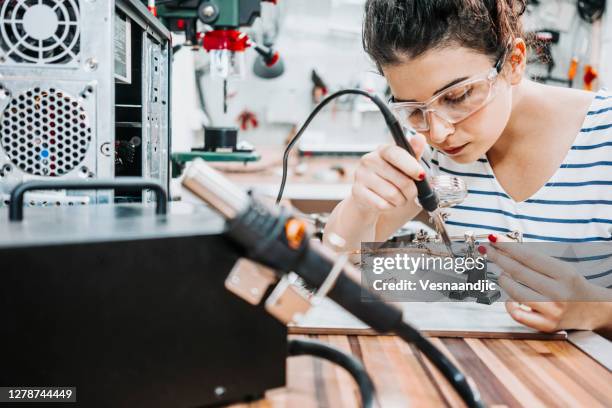 young woman repairing and assembling pc computer - soldered stock pictures, royalty-free photos & images