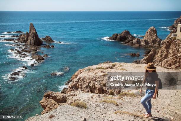 woman hiking in arrecife de las sirenas, cabo de gata, almeria, spain - cabo de gata stock pictures, royalty-free photos & images