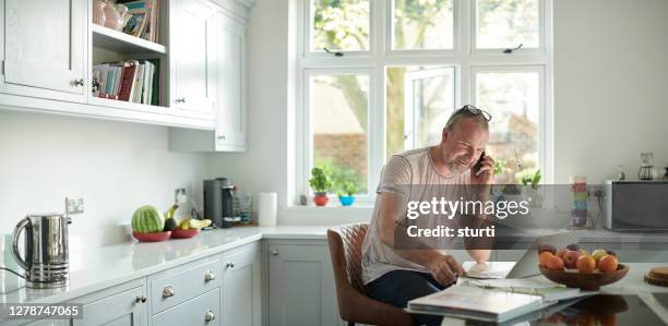 business as usual - man talking phone stock pictures, royalty-free photos & images