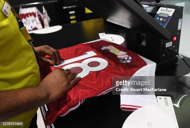 Member of staff prepares shirts featuring the name of Arsenal's new signing Thomas Partey in the Armoury store at Emirates Stadium on October 06,...