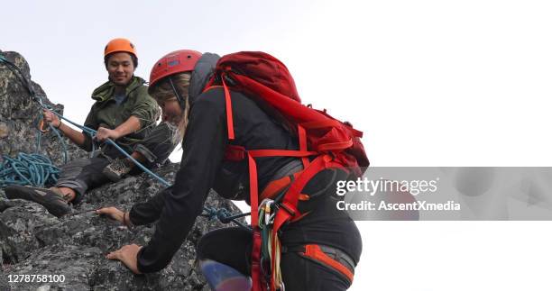 l'alpinista sale su un crinale di montagna - messa in sicurezza foto e immagini stock