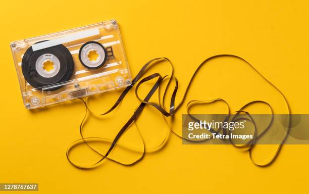 analog audio cassette on yellow background - audiocassette stock-fotos und bilder