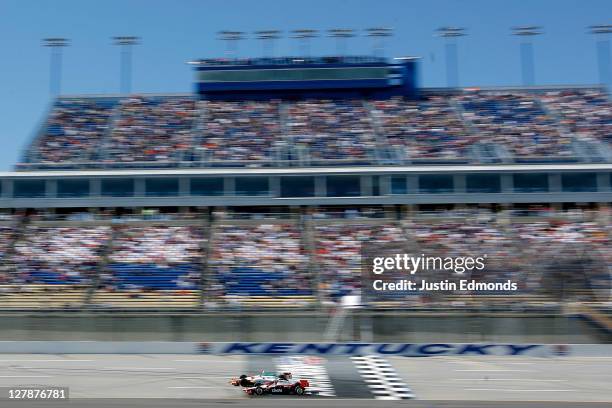 Helio Castroneves of Brazil, driver of the Cintas Team Penske Dallara Honda, and Charlie Kimball, driver of the Levemir and NovoLog FlexPen Novo...