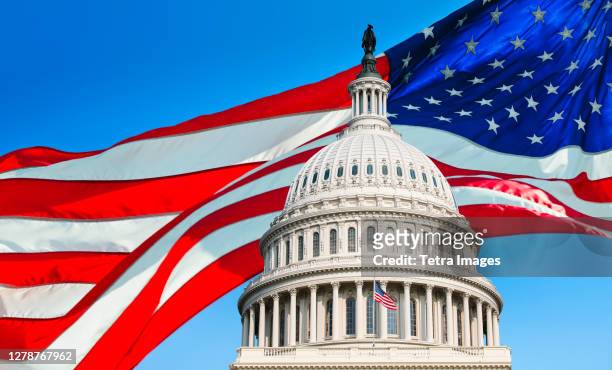 usa, washington d.c., capitol building against background of american flag - us politics stock pictures, royalty-free photos & images