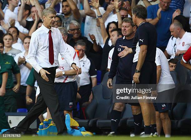 Arsenal manager Arsene Wenger shakes hands with Spurs staff after the match as Tottenham Hotspur assistant coach Clive Allen reacts in the Barclays...