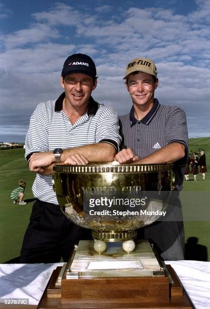 Nick Faldo and David Carter of England with the trophy after winning the World Cup of Golf at the Gulf Harbour Golf Club in Auckland, New Zealand. \...