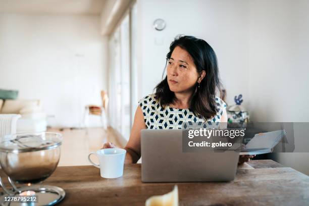 portrait of elegant business woman working at laptop on wooden table - woman portrait in home laptop stock pictures, royalty-free photos & images