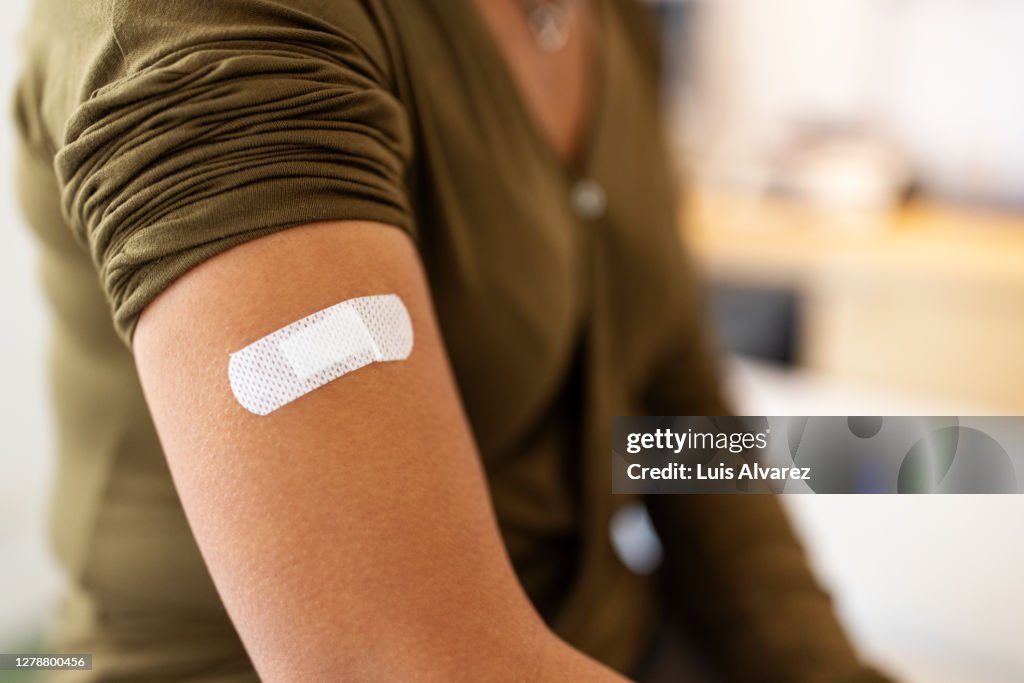 Bandage on arm of a female after taking vaccine