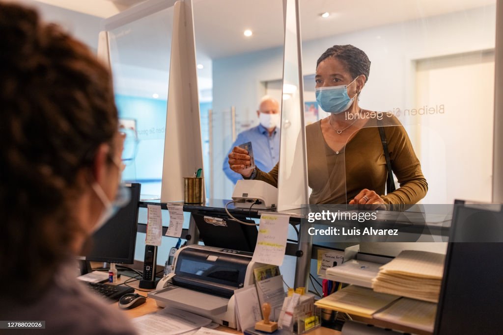 Patient talking to hospital receptionist