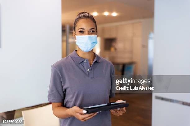 female nurse in hospital waiting room - arztpraxis empfang stock-fotos und bilder