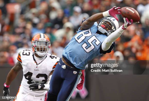Wide receiver Nate Washington of the Tennessee Titans makes a catch in front of defensive back T.J. Ward of the Cleveland Browns at Cleveland Browns...
