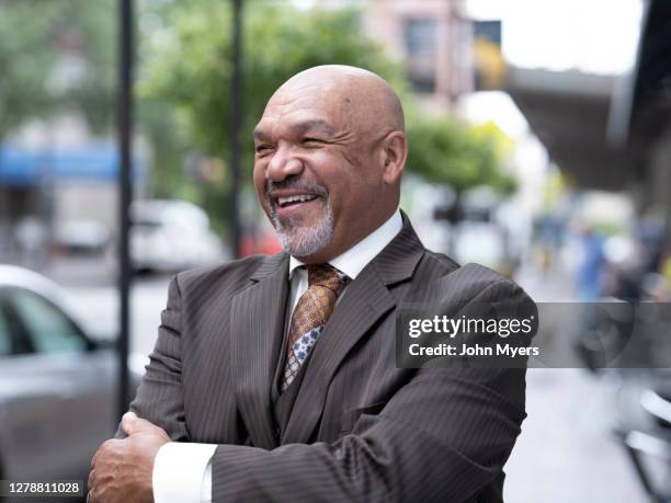 mixed race male on a city street - rochester bundesstaat new york stock-fotos und bilder