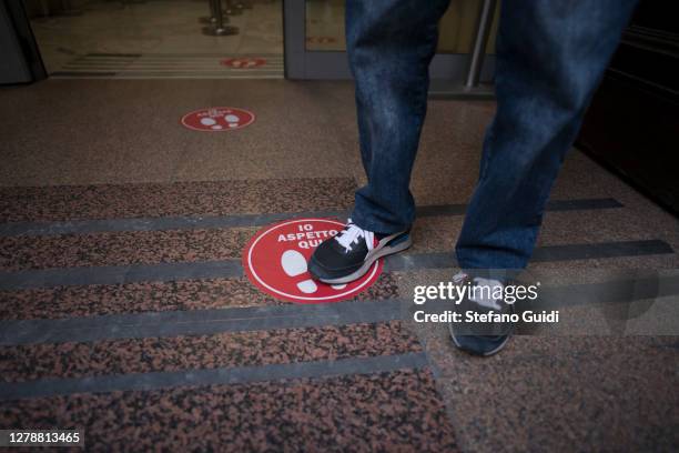 Man's feet on a social distancing mark on the ground all' entrata del Presidio Ospedaliero Sperino Oftalmico di Torino on October 06, 2020 in Turin,...
