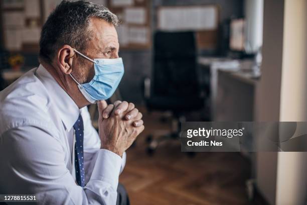 business man with a face mask, covid-19 - protective face mask side stock pictures, royalty-free photos & images