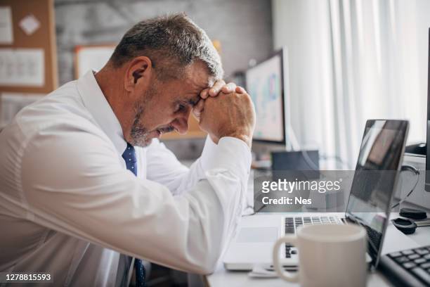 worried businessman in the office - gray hair stress stock pictures, royalty-free photos & images