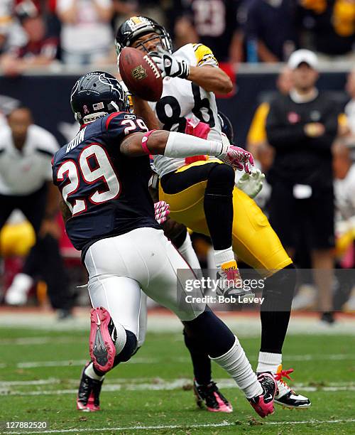 Wide receiver Hines Ward of the Pittsburgh Steelers drops the ball after taking a hard hit from cornerback Jason Allen and strong safety Glover Quin...