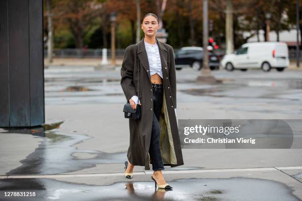 Sophia Roe is seen wearing white cropped top, grey coat, denim jeans, black bag, heels outside Chanel during Paris Fashion Week - Womenswear Spring...