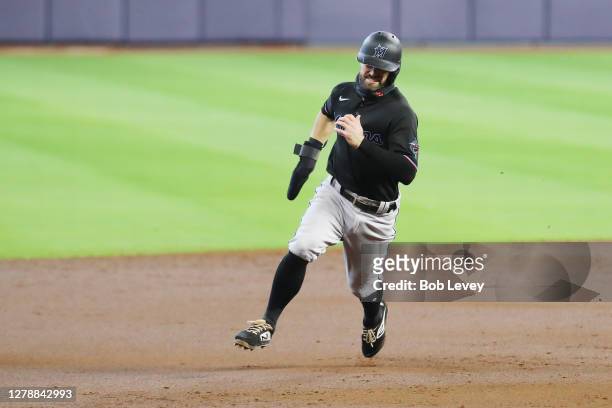 Jon Berti of the Miami Marlins scores on a two run double by Garrett Cooper during the third inning against the Atlanta Braves in Game One of the...