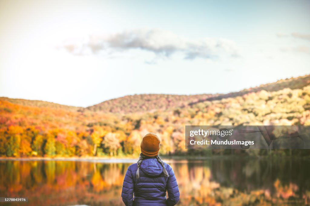 Young Woman in Autumn Landscape.