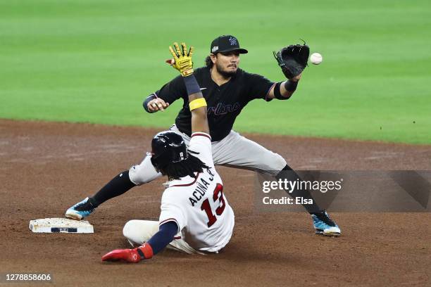 Ronald Acuna Jr. #13 of the Atlanta Braves is out by Miguel Rojas of the Miami Marlins at second during the seventh inning in Game One of the...