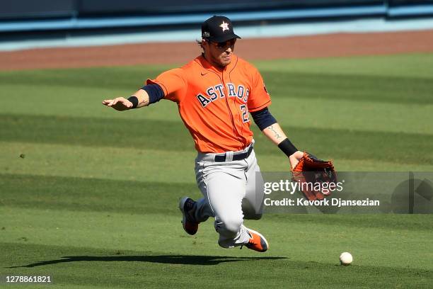 Josh Reddick of the Houston Astros misses a catch allowing Khris Davis of the Oakland Athletics a single during the fourth inning in Game Two of the...