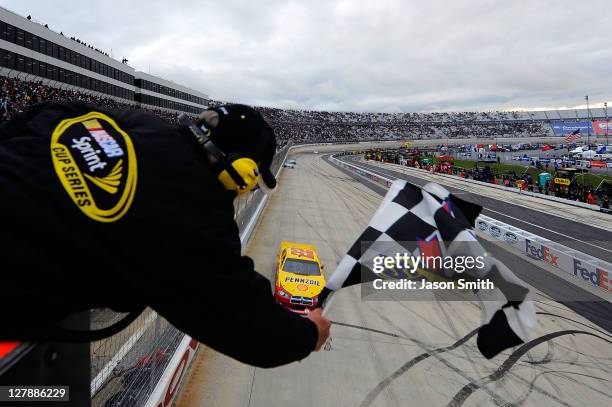 Kurt Busch, driver of the Shell/Pennzoil Dodge, heads across the start/finish line to take the checkered flag and win the NASCAR Sprint Cup Series...