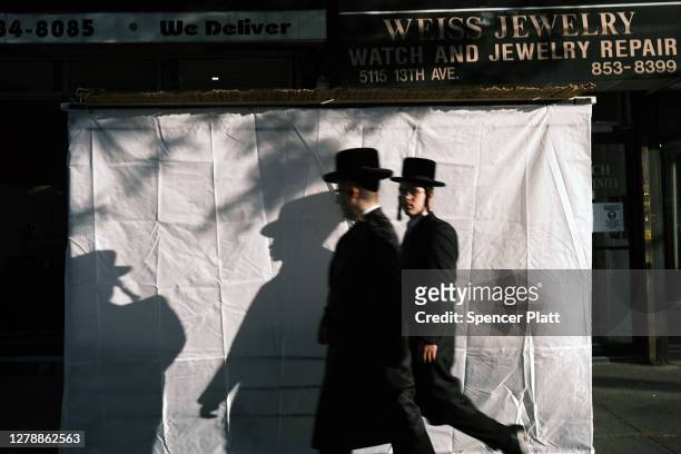 Residents walk along a street in the Brooklyn neighborhood of Borough Park on October 06, 2020 in New York City. Borough Park is one of numerous...