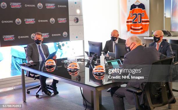 General manager Ken Holland of the Edmonton Oilers sits at the draft table with team personnel before the first round of the 2020 NHL Entry Draft at...