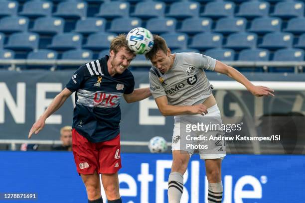 Henry Kessler of New England Revolution and Lassi Lappalainen of Montreal Impact battle for head ball during a game between Montreal Impact and New...