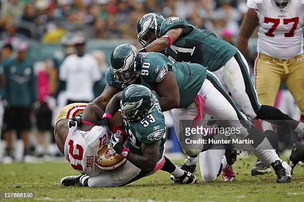 Outside linebacker Moise Fokou, defensive tackle Antonio Dixon, and strong safety Jarrad Page of the Philadelphia Eagles tackle running back Frank...