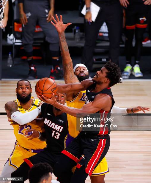 Jimmy Butler of the Miami Heat drives on Markieff Morris of the Los Angeles Lakers as Bam Adebayo of the Miami Heat and LeBron James of the Los...