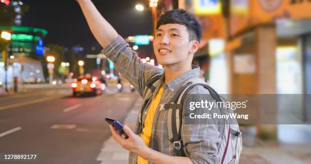 asian man hail a taxi - taiwan night market stock pictures, royalty-free photos & images