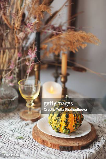 fall decor halloween style table setting with candles, pampas grass, reeds, pumpkins. rustic style - fall decor stock pictures, royalty-free photos & images