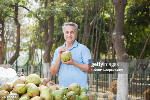 mature man in garden - stock photo - coconut water stock pictures, royalty-free photos & images