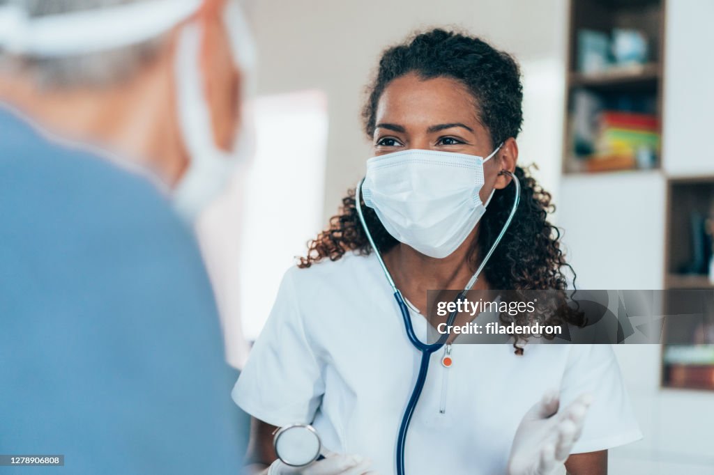 Doctor visiting a senior woman at home