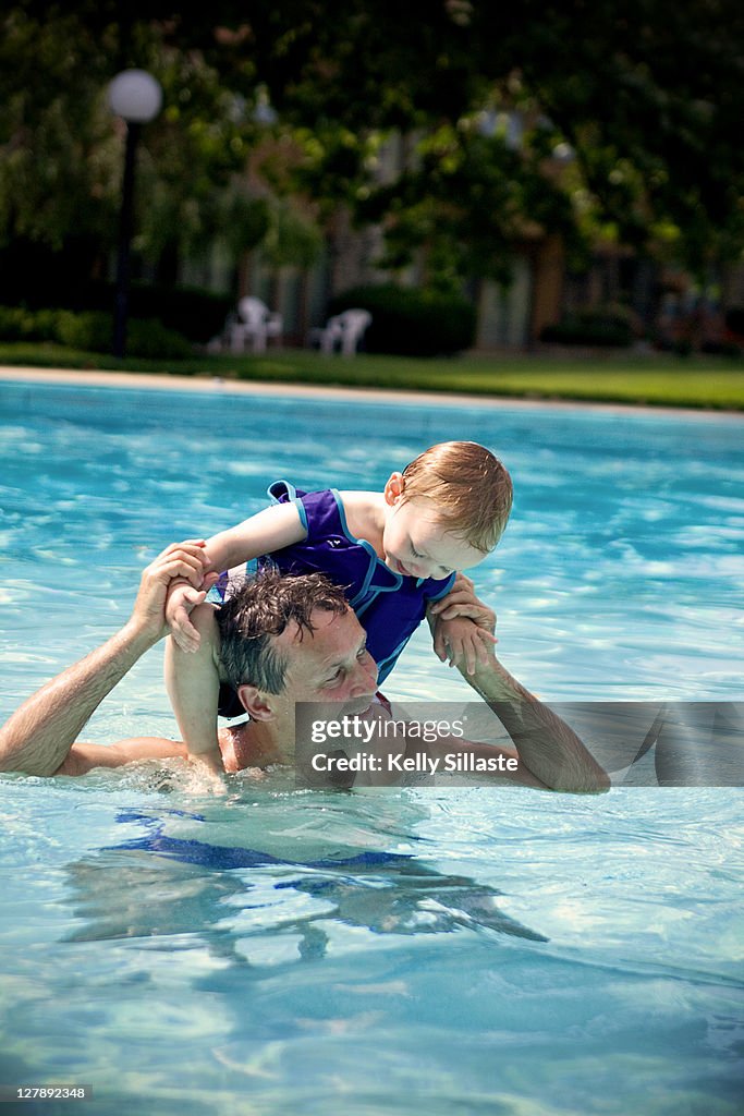 Father with his toddler son on his shoulders