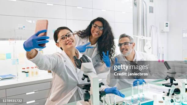 multi ethnic laboratory team at work. making funny faces on selfie - futurism stock pictures, royalty-free photos & images