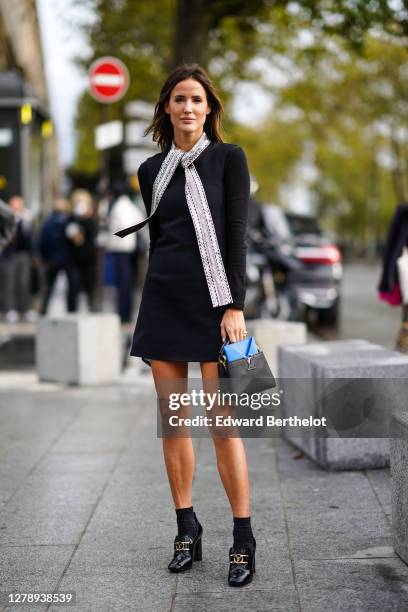 Alex Riviere wears a black dress, a silver scarf, a bag, Vuitton shoes, outside Louis Vuitton, during Paris Fashion Week - Womenswear Spring Summer...