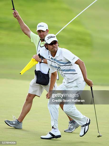 Kevin Na celebrates his birdie putt on the 17th green with his caddie Kenny Harms during the final round of the Justin Timberlake Shriners Hospitals...