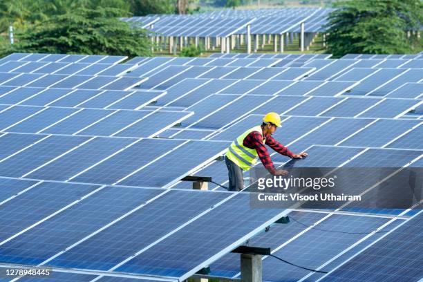 team electrician installing solar panels working on alternative energy sources clean. - clean house stockfoto's en -beelden