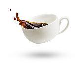 A cup of coffee with splash isolated on a white