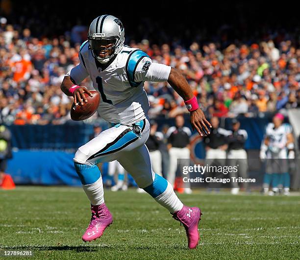 Carolina Panthers quarterback Cam Newton scrambles and scores a touchdown in the second quarter against the Chicago Bears at Soldier Field in...
