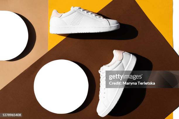 white sneakers on a multicolored background in a geometric style. - weiße schuhe stock-fotos und bilder