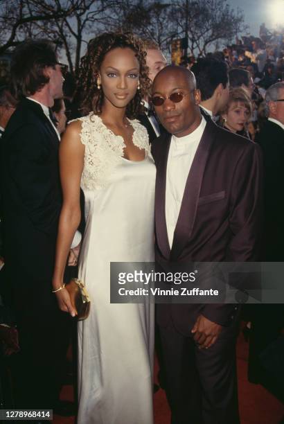American supermodel Tyra Banks and American film director, screenwriter, producer, and actor John Singleton during 1994 Vanity Fair Oscar Party at...