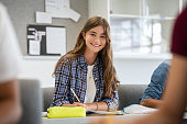 Smiling college girl studying in classroom